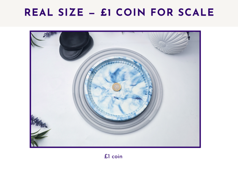 Small blue marbled oval tray beside a £1 coin for size comparison