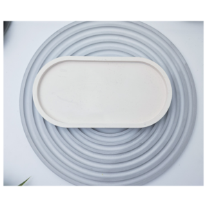 White oval tray photographed from above on a grey ribbed background.