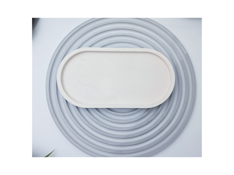 White oval tray photographed from above on a grey ribbed background.