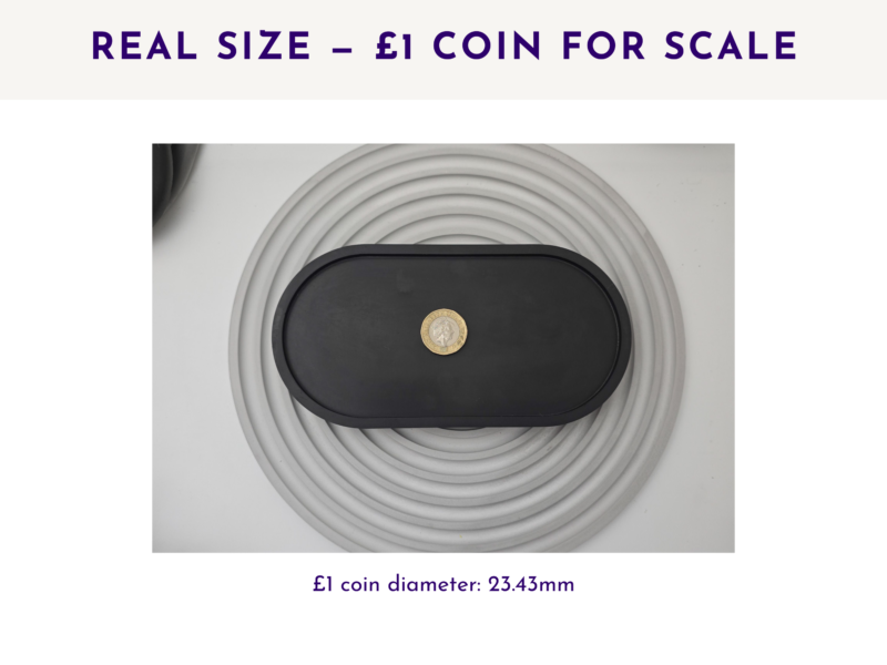 Black oval tray with a £1 coin placed in the centre for size reference.