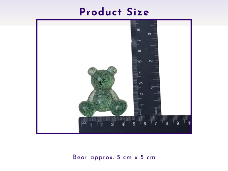 Small green speckled teddy bear beside a ruler, showing it is about 5 cm by 5 cm