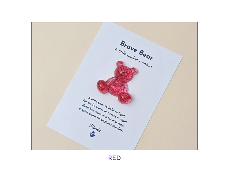 Tilted white card on a beige background featuring a red glittery bear and the title 'Brave Bear'