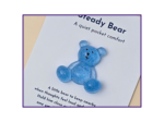 Steady Bear glitter pocket companion in blue on printed support card, shown as the main product image on a neutral background.