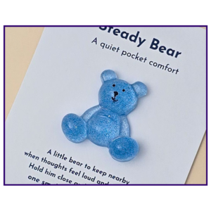Steady Bear glitter pocket companion in blue on printed support card, shown as the main product image on a neutral background.