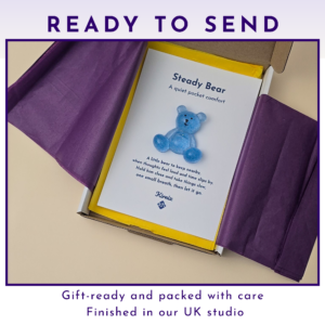 Steady Bear pocket companion gift-boxed with purple tissue paper and backing card, ready to send.