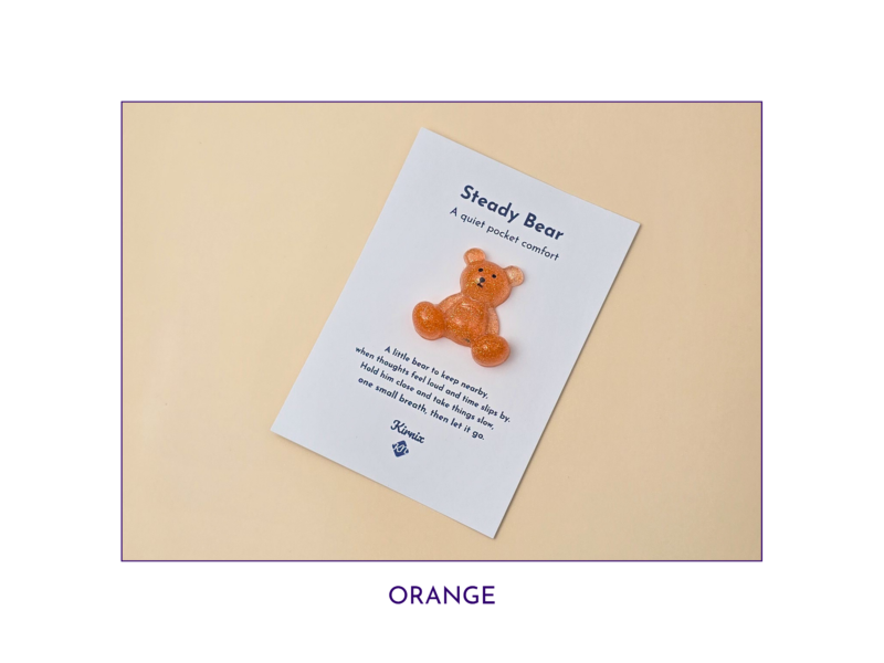 Steady Bear glitter pocket companion in orange on its printed support card.