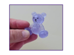and holding the Steady Bear glitter pocket companion to show scale, finish, and how it looks in real use.