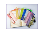 KXK-RBMK-01 Colorful glittery bookmarks with tassels laid across an open book.