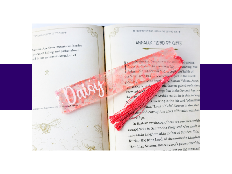 Open book page showing the heading 'Annatar, Lord of Gifts' with a pink glittery bookmark stretched across the text.