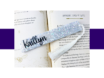 KXK-RBMK-16 Open fantasy book with a glittery silver star-pattern bookmark and white tassel laid across the pages.