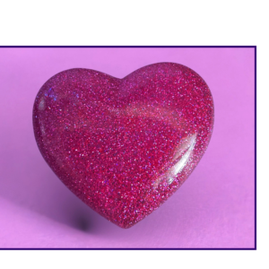 Glittery pink heart against a soft purple background