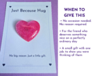 Glittery pink heart on a white card that reads 'Just Because Hug' against a purple background.