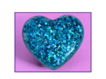 Blue glitter-covered heart on a pink background with a dark purple border, decorative image