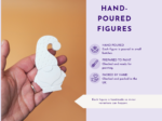 KNP-PYO-GNOMEs-0088. Handmade_detail Close-up of a hand holding a small white hand-molded figure against an orange background, with a lavender panel on the right showing 'HAND-POURED FIGURES' and related text.