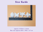 Size Guide: white butterfly shapes and a measuring ruler laid on a peach background against a purple page.