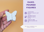Close-up of a hand holding a white butterfly figurine; on the right, a lavender infographic panel reads 'HAND-POURED FIGURES'.