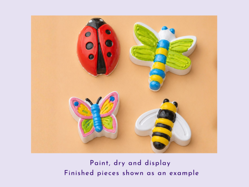 Colorful ceramic insects (ladybug, butterfly, dragonfly, bee) arranged on a peach background as finished craft pieces drying.