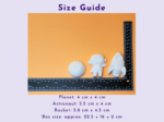 Size guide: orange background with a ruler beside white astronaut figurines for scale.