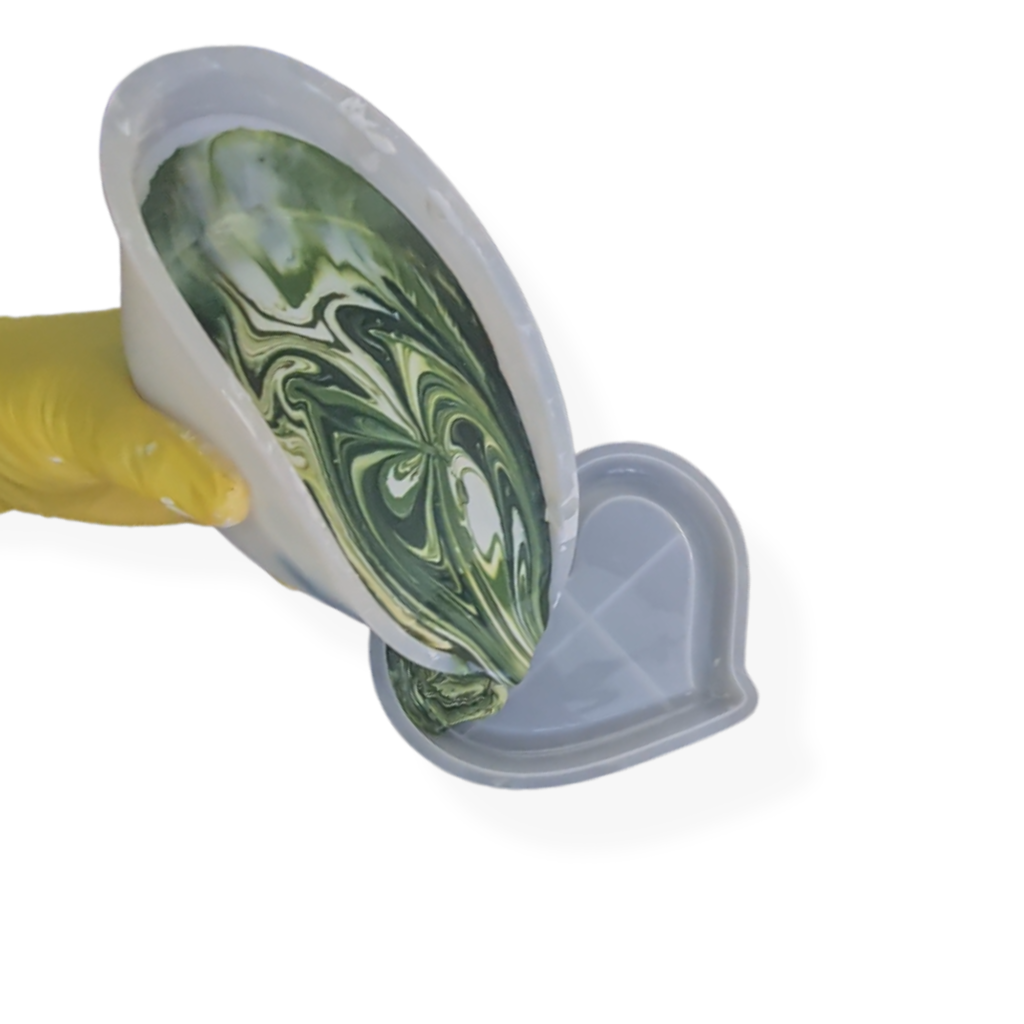Close-up of a disposable cup showing a green marbled interior and a yellow sleeve against a dark background.