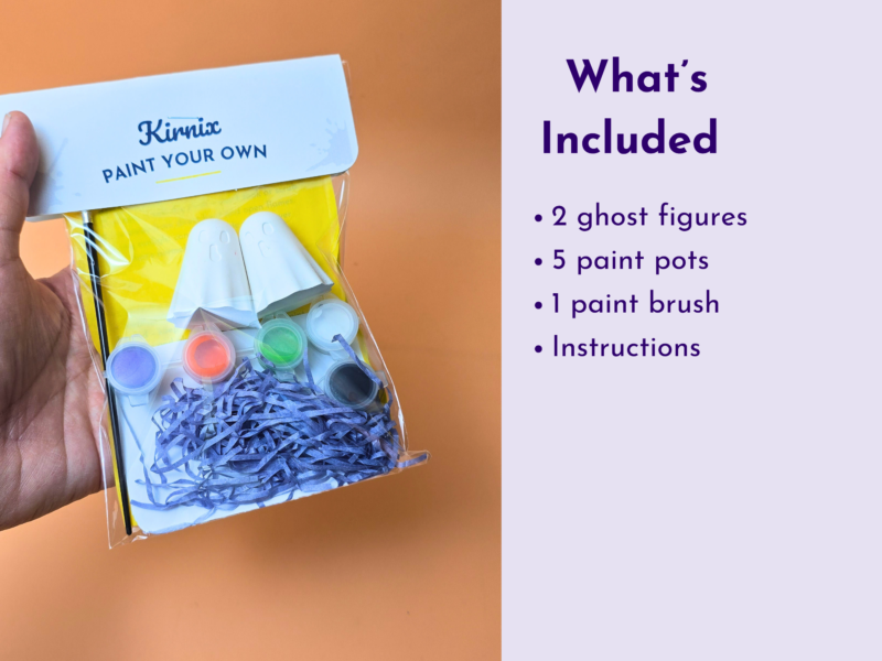 Hand holding a Kirnix 'Paint Your Own' craft kit with a blue box and colorful paints inside the bag.