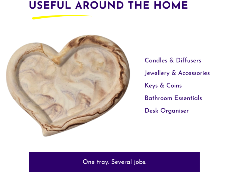 Left-aligned heart-shaped marble tray with a right-column list of home categories in purple text: Candles & Diffusers, Jewellery & Accessories, Keys & Coins, Bathroom Essentials, Desk Organiser; header 'Useful Around the Home' with a yellow underline.