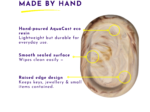Infographic-style image highlighting features of a hand-poured AquaCast eco resin product, with yellow callouts around a carved ear and purple text headings.
