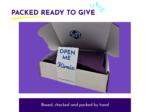 Card saying 'OPEN ME' inside an open cardboard box against a solid purple background; the heading above reads 'PACKED READY TO GIVE'.