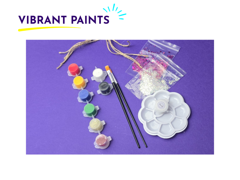 Paint supplies spread on a purple background: small paint pots, brushes, glitter in zip bags, and a white plastic palette with compartments.