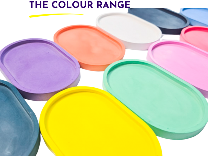 Colorful overlapping paint lids forming a rainbow palette, with the heading 'THE COLOUR RANGE' at the top and a yellow underline under the title.