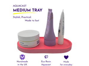 AQUACAST Medium Tray advertisement showing purple tubes and a white jar on a pink tray with the headline 'Medium Tray' and the tagline 'Stylish, Practical. Made to last.'