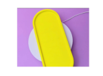 Close-up of a bright yellow object with curved edges on a purple background.