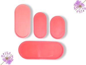 Row of pink oval silicone blocks on a white background with purple allium flowers in the corners.