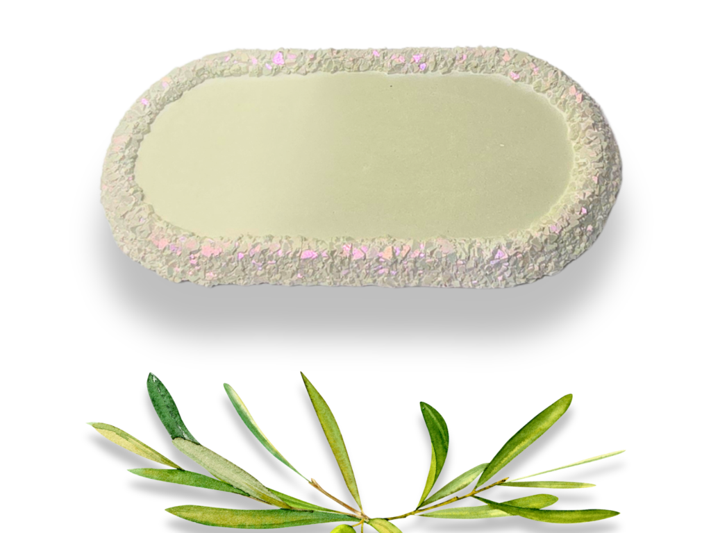 Handmade olive green elongated trinket tray with a smooth pale green centre and textured druzy-effect edge with subtle pink and iridescent shimmer.
